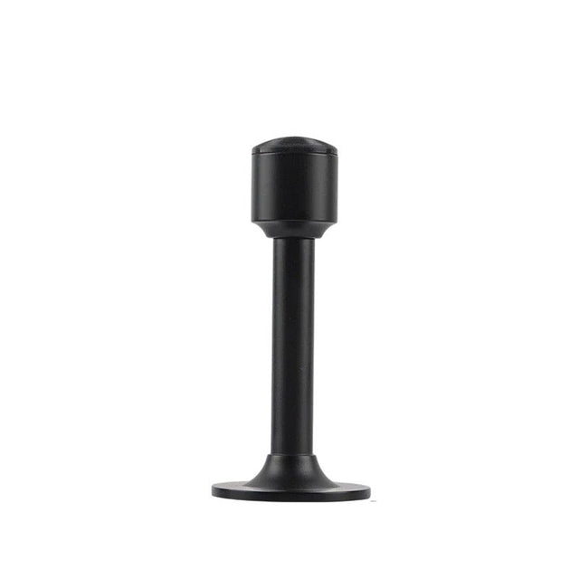 "Sculpted brass door stop with a sleek, tapered silhouette, matte black polished finish, wide stable base, and magnetic hold, designed to prevent wall damage."