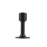 "Sculpted brass door stop with a sleek, tapered silhouette, matte black polished finish, wide stable base, and magnetic hold, designed to prevent wall damage."