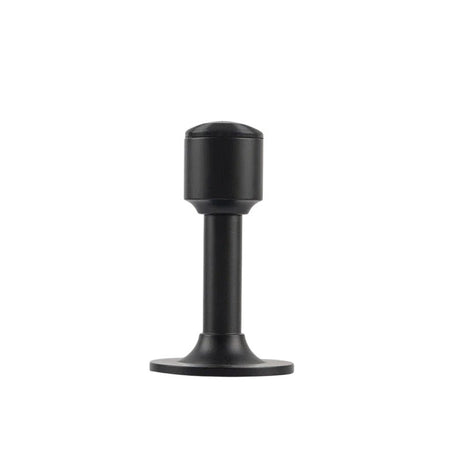 "Sculpted brass door stop with a sleek, tapered silhouette, matte black polished finish, wide stable base, and magnetic hold, designed to prevent wall damage."