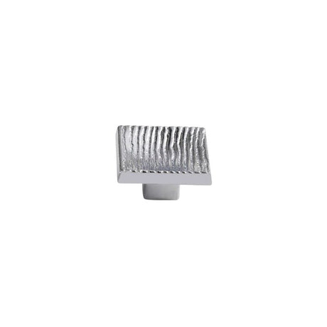 "Studio shot of a single polished nickel square cabinet knob with a ridged, textured surface on a white background."