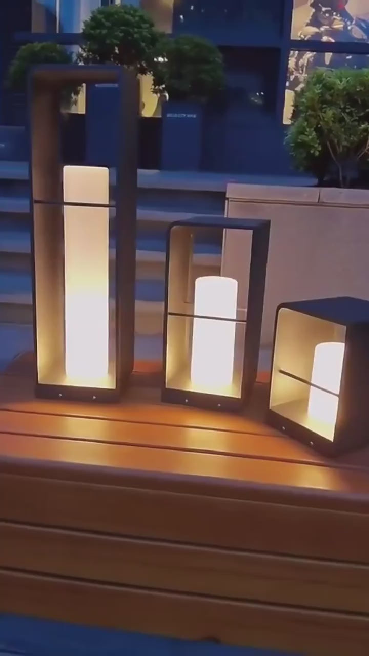 Zence Outdoor Garden Lamp - Durable & Solar Powered trio glowing on a wooden bench, perfect for stylish outdoor evening lighting.