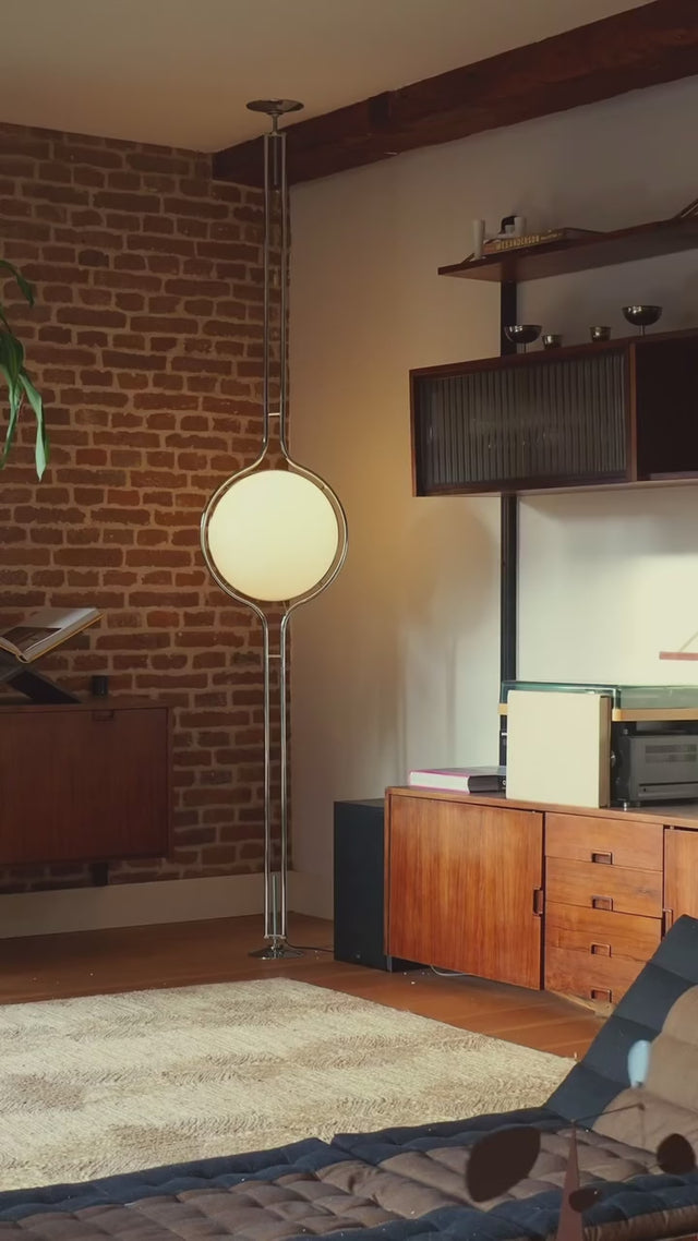 Zuru floor-to-ceiling lamp installed in a mid-century modern living room, blending ambient lighting with stylish decor.