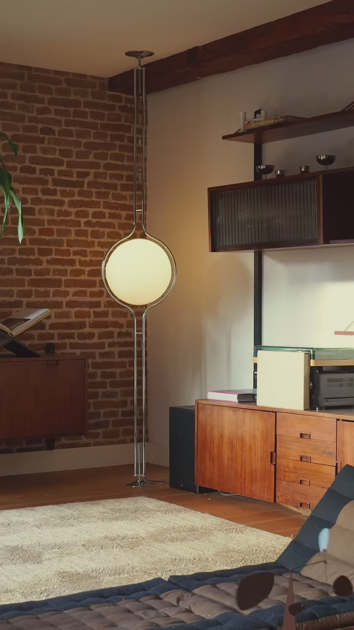 Zuru floor-to-ceiling lamp installed in a mid-century modern living room, blending ambient lighting with stylish decor.