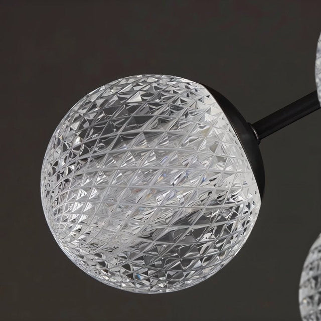 "Detailed view of the textured acrylic diffuser on a starburst chandelier."