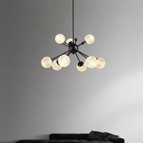 "Starburst chandelier with iron arms and textured acrylic diffusers, featuring eight lights, hanging above a living room sofa."