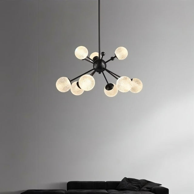 "Starburst chandelier with iron arms and textured acrylic diffusers, featuring eight lights, hanging above a living room sofa."