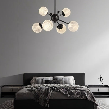 "Starburst chandelier with iron arms and textured acrylic diffusers, hanging above a contemporary bed."