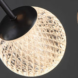 "Close-up of a textured acrylic diffuser on an iron starburst chandelier."