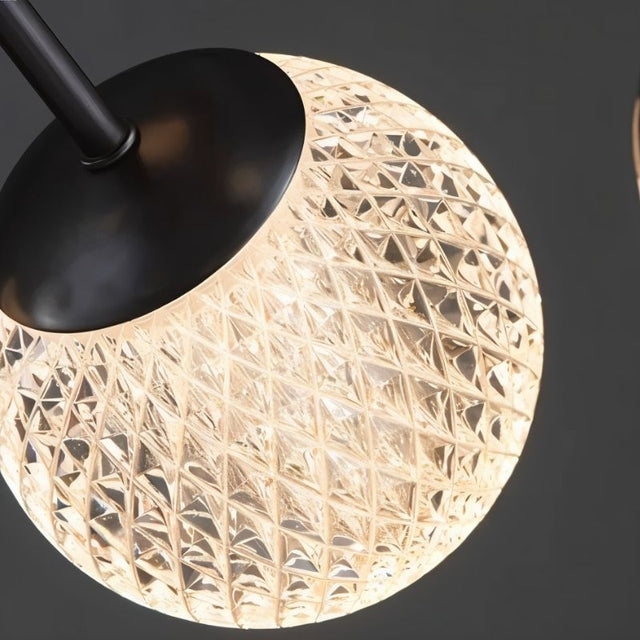 "Close-up of a textured acrylic diffuser on an iron starburst chandelier."