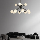 "Starburst chandelier with iron arms and textured acrylic diffusers, hanging above a living room with modern furniture."
