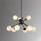 "Starburst chandelier with iron arms and textured acrylic diffusers, hanging against a gray background."