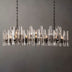 Prizma Linear Chandelier with glass accents and black metal finish, hanging against a plain gray background.