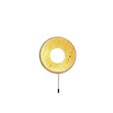 "Round yellow travertine wall sconce with a pull switch, showcasing its unique design and natural materials."