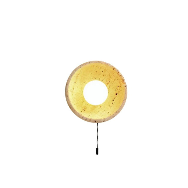 "Round yellow travertine wall sconce with a pull switch, showcasing its unique design and natural materials."
