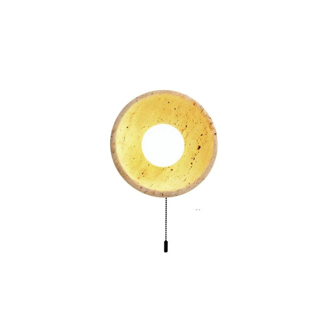 "Modern travertine wall lamp with a circular design and a convenient pull chain switch."