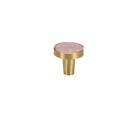 "A round brass cabinet knob with a pink shell inlay, isolated on a white background."