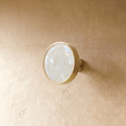 "Modern luxury brass knobs and pull bars with shell inlays, featuring pearl and abstract textures for contemporary interiors."