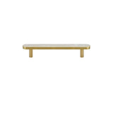 "Flat lay of a modern brass pull bar with a white shell inlay, isolated on a white background."