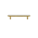 "A modern brass pull bar with a white shell inlay, isolated on a white background."