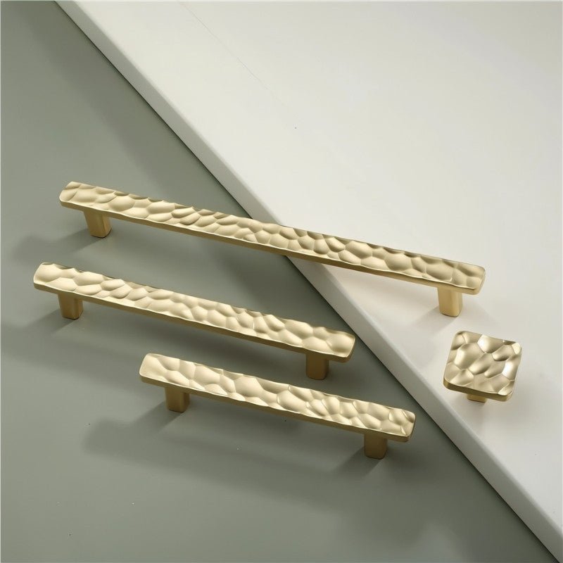 "Group of hammered texture cabinet knobs and pull bar handles in various sizes, showcasing their modern and artisanal design."