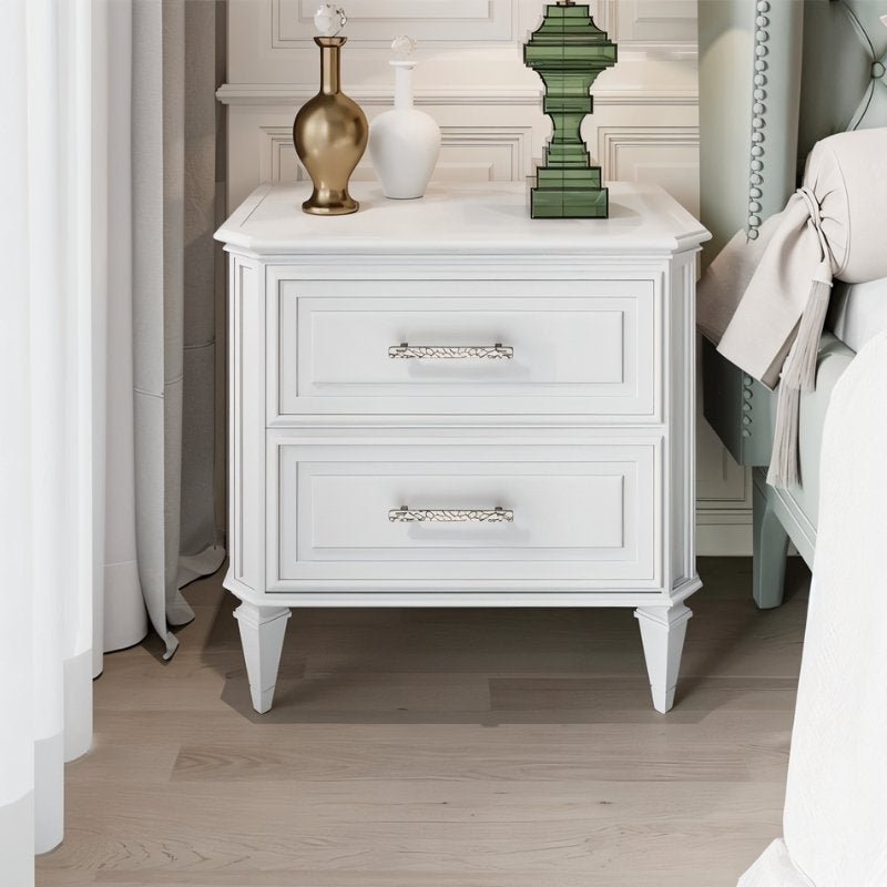 "Silver hammered texture pull bar handles on a white nightstand, adding a modern artisanal touch."