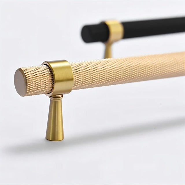 "Close-up of precision-crafted brass knurled pull bar handles in black and gold finishes, highlighting the textured grip and sleek metallic look."