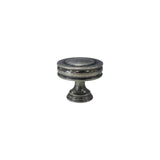 "Front view of a vintage-inspired brass knob with layered ridges and a distressed finish."