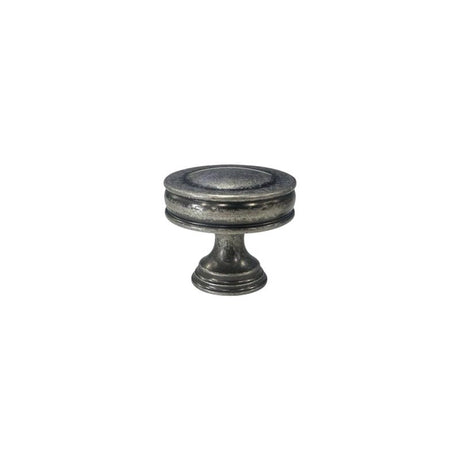 "Front view of a vintage-inspired brass knob with layered ridges and a distressed finish."