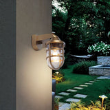 "A gray, industrial-style wall lamp with a robust cage structure and clear PC diffuser, blending rugged design with contemporary elegance for indoor and outdoor use."