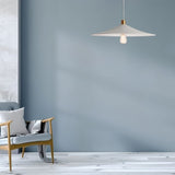"Raida pendant light with a minimalist conical design, hanging in a modern living room with soft blue walls, creating a warm and inviting ambiance."