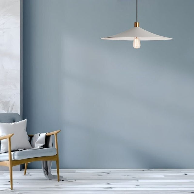 "Raida pendant light with a minimalist conical design, hanging in a modern living room with soft blue walls, creating a warm and inviting ambiance."