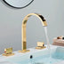 Gold widespread bathroom faucet with curved spout flowing water into a white sink basin.