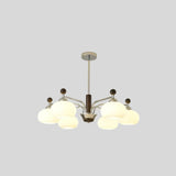 "Isolated Ralie chandelier with silver iron, wood, and frosted glass globes on a light grey background."
