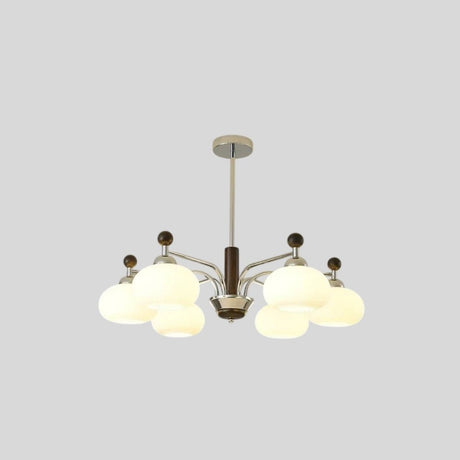 "Isolated Ralie chandelier with silver iron, wood, and frosted glass globes on a light grey background."
