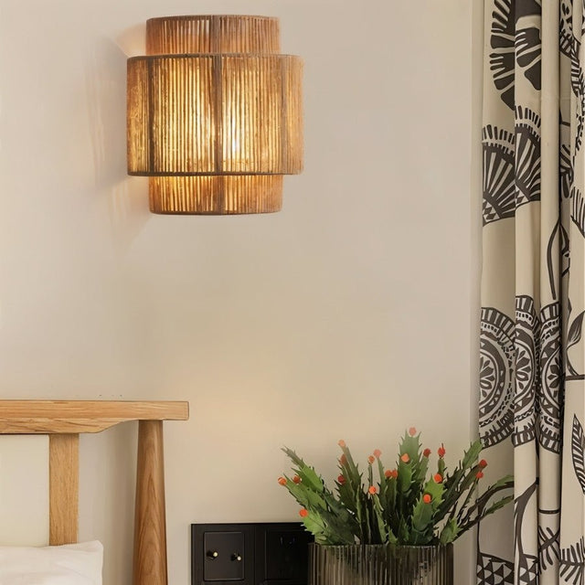 "A rustic bedroom wall lamp made of bamboo, rattan, and hemp, adding a warm, patterned glow to the decor."