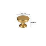 Dimensions of a solid brass cabinet knob with a cylindrical design and machined detailing, shown with measurements in inches and centimeters."