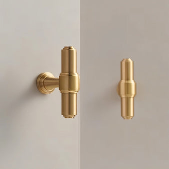 "A solid brass cylindrical knob and pull bar with machined detailing, suitable for cabinetry and furniture."