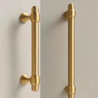 "Two views of a solid brass pull bar handle with a cylindrical design and machined details, suitable for modern and classic interiors."