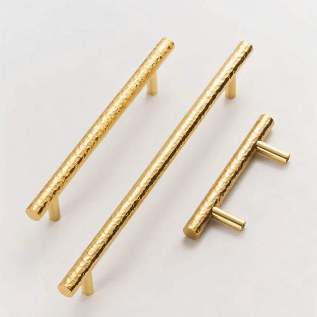 "Modern hammered brass pull bars in three sizes, showcasing their textured, artisanal design for cabinetry and doors."