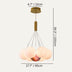 Brass pendant chandelier with frosted glass globe shades and copper accents on cream background.
