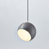 Gray spherical pendant light with cream-colored diffuser hanging from dark cord against white background.