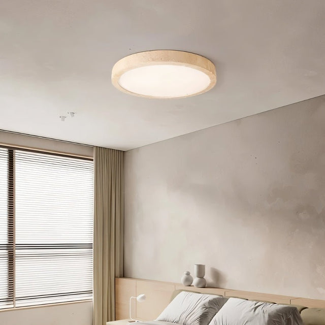  "A minimalist, natural travertine Richna ceiling light illuminates a modern bedroom with soft, uniform light near a window."