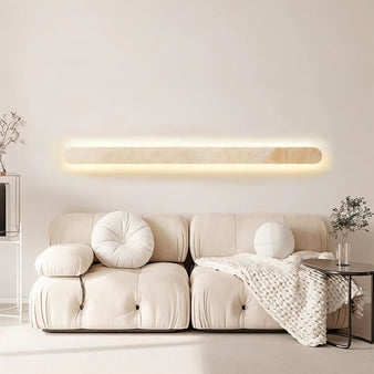 "Elegant travertine wall light mounted above a cozy sofa in a modern living room"