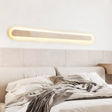 "Natural travertine wall light illuminating a bedroom with soft, ambient lighting"