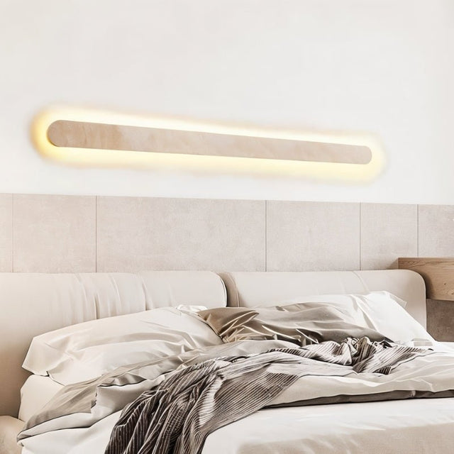 "Natural travertine wall light illuminating a bedroom with soft, ambient lighting"