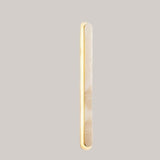 "Side view of a natural travertine wall light with elegant elongated structure"