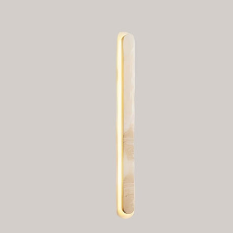 "Side view of a natural travertine wall light with elegant elongated structure"