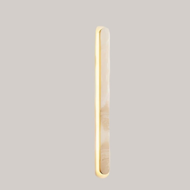 "Side view of a natural travertine wall light with elegant elongated structure"