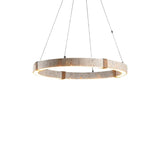 "Industrial-style circular chandelier made of travertine, iron, and acrylic, with an integrated LED strip for a warm, diffused light."