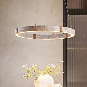 "Modern rustic chandelier with a circular travertine frame, iron accents, and a warm LED glow, creating a statement piece."